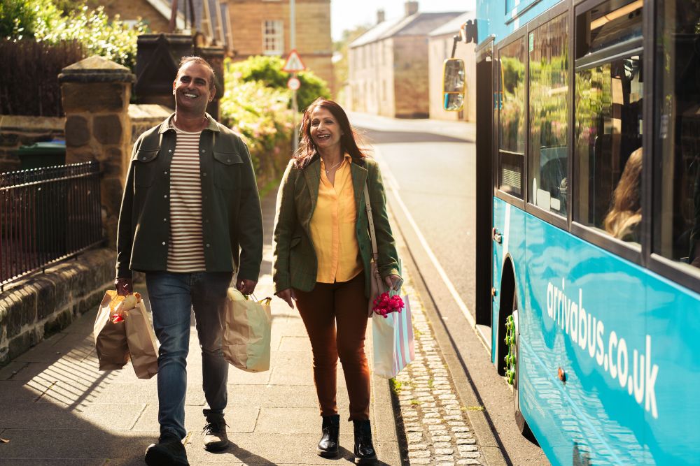 Bus customers walking alongside a bus